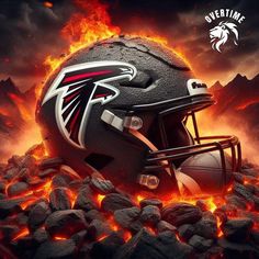 a football helmet sitting on top of a pile of rocks with flames in the background