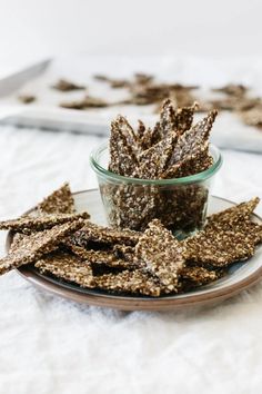 a glass bowl filled with some kind of cracker on top of a white table