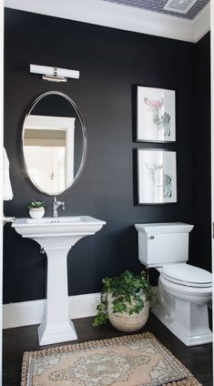 a bathroom with black walls and white fixtures