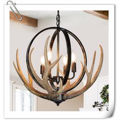 a deer antler chandelier hanging from the ceiling in a room with white walls