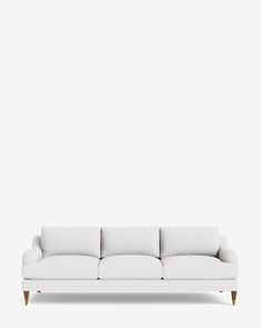 a white couch sitting on top of a wooden floor