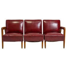 two red leather chairs sitting next to each other