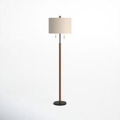 the floor lamp is made from wood and has a beige shade on it's base