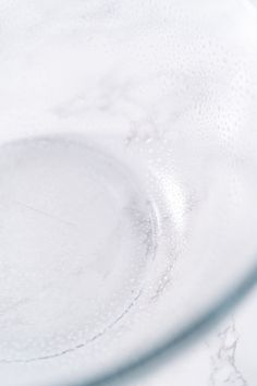 a close up view of a glass plate with water droplets on it and the edge of the plate