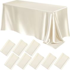 white tablecloths and napkins laid out on top of each other