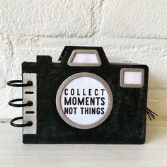 a black and white photo album with the words collect moments not things written on it