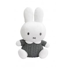 a white stuffed rabbit sitting in front of a white background and wearing a black shirt