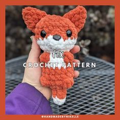 a hand holding a small crochet fox toy with the words fox on it