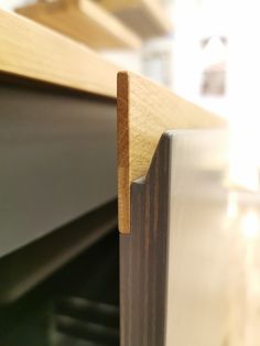 a close up view of the corner of a wooden shelf