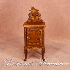 an old fashioned wooden cabinet with carvings on the front and sides, against a pink background