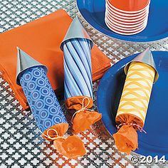 blue plates and orange napkins on a table