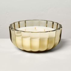 a candle that is sitting inside of a glass bowl