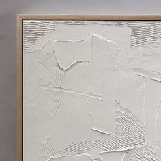 an abstract painting with white paint and wood frame