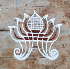 a drawing on the side of a building with a lotus design painted in white and red