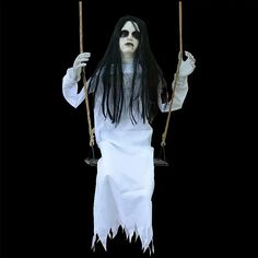 a woman dressed as a ghost holding two swings in one hand and wearing white gloves on the other