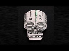 a money origami mask with the words survive on it's face and two dollar bills sticking out of its mouth