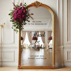 a mirror with flowers on it in front of a wedding sign that says, welcome to the wedding of hazel and charlie