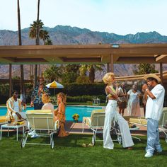 a group of people standing next to each other near a pool