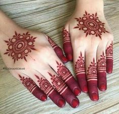 two hands with henna tattoos on them, one is red and the other is white