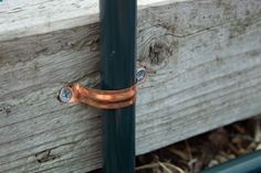 a close up of a metal handle on a wooden post