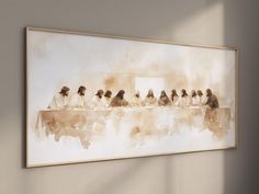 a painting hanging on the wall with people sitting at a long table in front of it