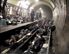 many people are laying on the tracks in a tunnel