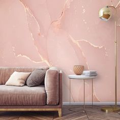 a living room with pink marble wallpaper and a gold lamp on the side table