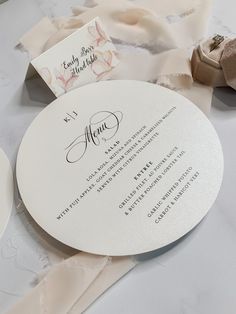 a table topped with white plates and napkins