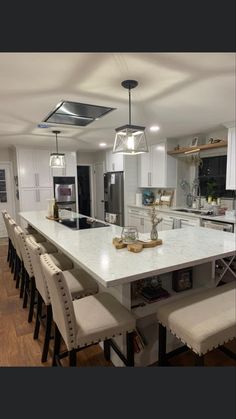 a large kitchen with an island in the middle