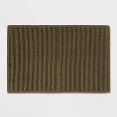 an olive green rug on a white background