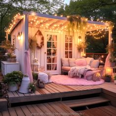 an outdoor living area with lights on the roof and pink rugs in front of it