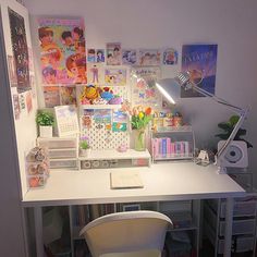 a white desk topped with lots of clutter