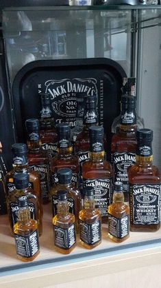 bottles of jack daniels are sitting on a shelf