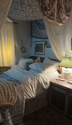 a bed sitting under a canopy in a bedroom