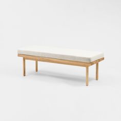 a bench made out of wood and fabric with a cushion on the backrest, in front of a white background