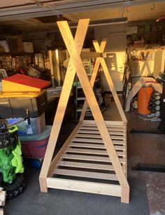 a wooden structure sitting inside of a garage