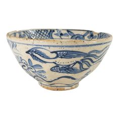 a blue and white bowl with fish on it