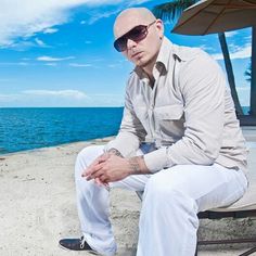 a man sitting on top of a bench next to the ocean