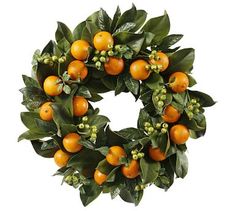 an orange wreath with green leaves and berries