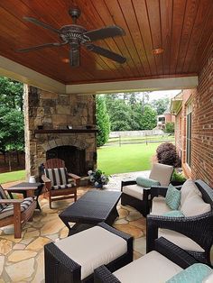 an outdoor living area with furniture and a ceiling fan