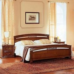 a bed room with a neatly made bed and two night stands on the rugs