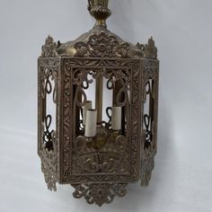 an ornate metal lantern with candles in it