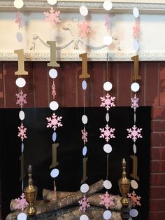 a fireplace decorated with pink and white snowflakes