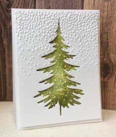 a card with a green christmas tree on it