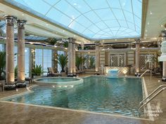 a large indoor swimming pool surrounded by columns