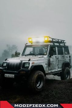 an off road vehicle with its lights on in the fog