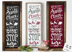 two framed christmas signs with santa claus and please stop here on them, hanging from the wall