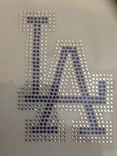 a close up view of the la lakers logo on a laptop computer screen with blue and white dots