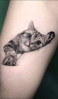 a small cat tattoo on the right thigh, with an eyeball in it's mouth