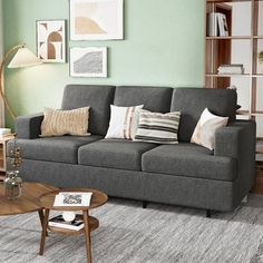 a living room filled with furniture and green walls